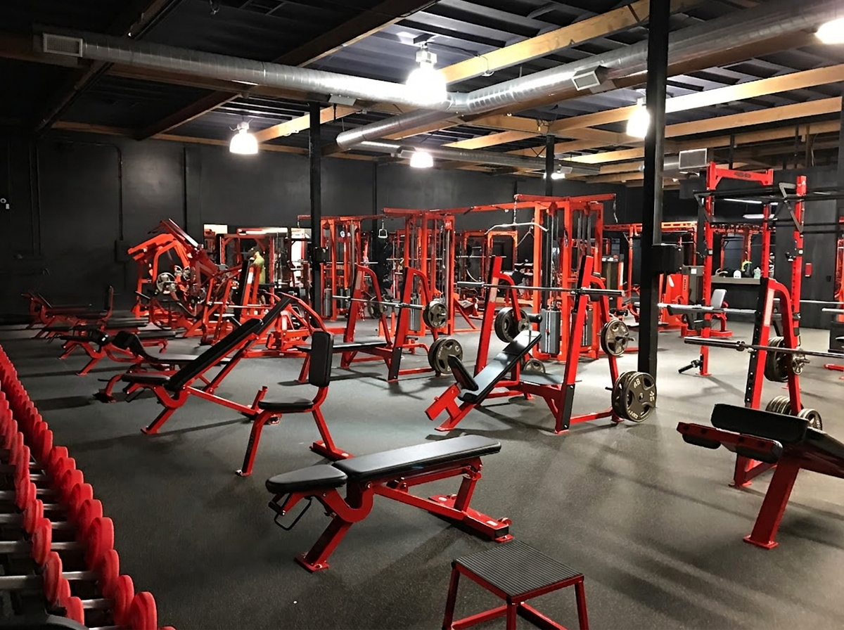 The Ambition training floor with red strength equipment in Costa Mesa